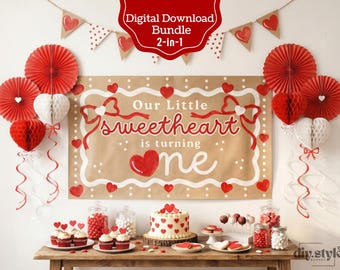 May include: A festive party decoration set with a banner that reads "Our Little Sweetheart is turning one." The scene includes red and white paper fans, heart-shaped decorations, cupcakes, a cake, and candies, all arranged on a wooden table.