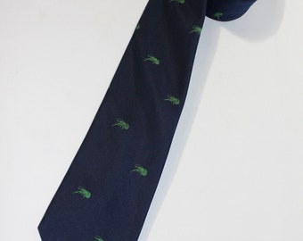 vintage 1980's -Cape Cod Neckwear- Men's neck tie. Jacquard wove, Green 'Crayfish' emblem stripe on Navy Blue twill. Polyester. 3 1/8"