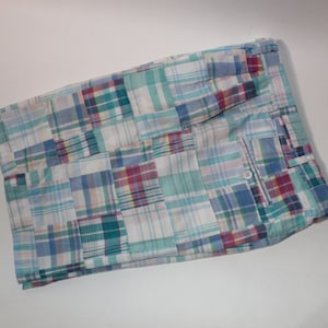 May include: Patchwork shorts with a blue, green, pink, and white plaid pattern.