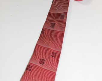 vintage 1950's narrow neck tie. Cranberry Red. Graduated stripes & floating cubes. Square ends.