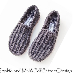 May include: A pair of gray crocheted slippers with a black and white checkered lining. The slippers have a simple design and are perfect for keeping your feet warm and cozy.