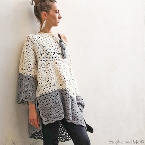 May include: Cream and gray crochet top with a square pattern design. The top has three-quarter sleeves and a loose fit. The bottom half and sleeves are gray, while the top is cream-colored. The top is handmade.