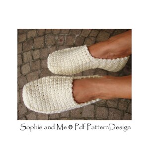 May include: A pair of white crocheted slippers. The slippers are made with a simple stitch pattern and have a comfortable, relaxed fit.