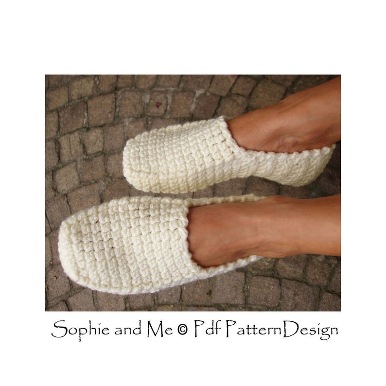 May include: A pair of white crocheted slippers. The slippers are made with a simple stitch pattern and have a comfortable, relaxed fit.