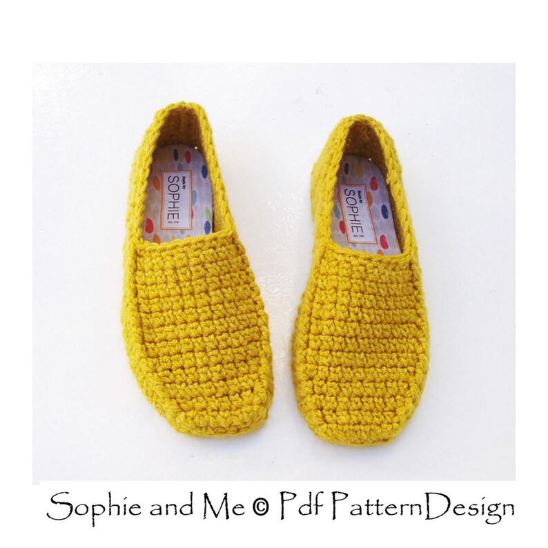 May include: A pair of yellow crocheted slippers with a white label that says "Made by Sophie".