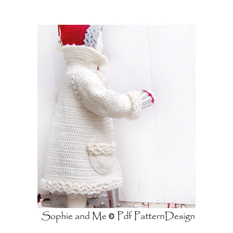 May include: A white crocheted coat with a ruffled hem and a pocket on the side. The coat is worn by a doll with a red and gray hat.