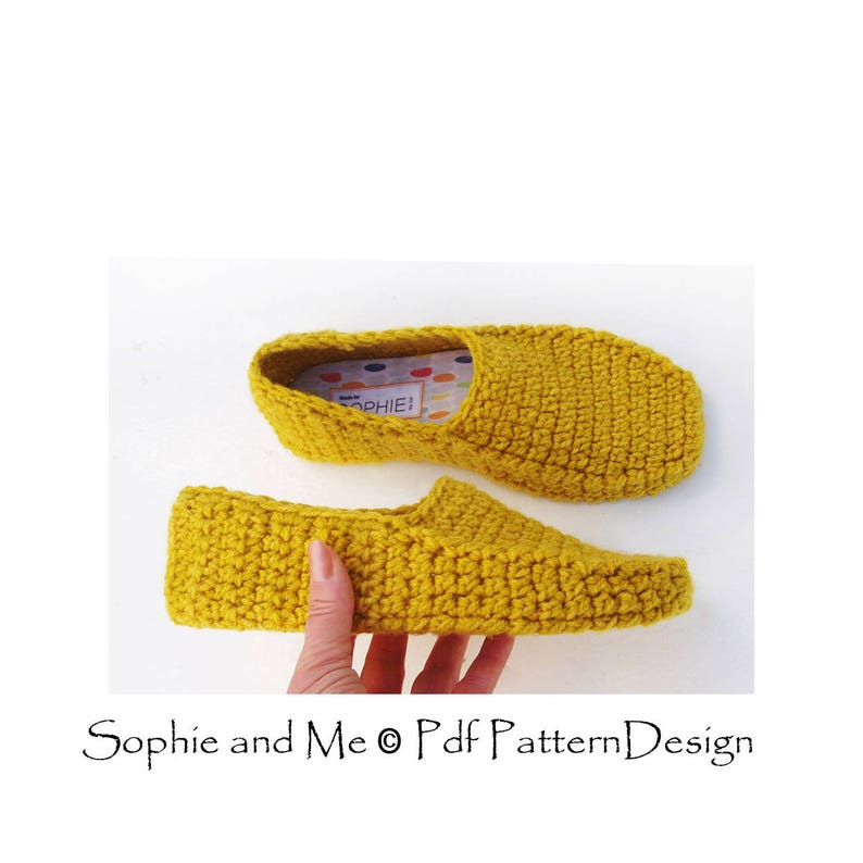 May include: A pair of yellow crocheted slippers. The slippers are made with a simple stitch and have a flat sole. The slippers are shown on a white background.