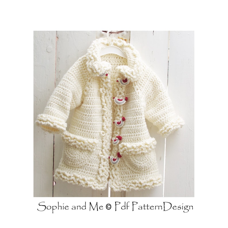 May include: A white crocheted cardigan with a ruffled trim, featuring red and gray buttons. The cardigan has pockets and a collar.