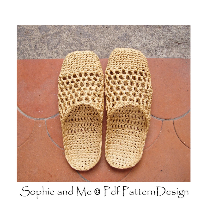 May include: A pair of beige crocheted slippers with a woven pattern. The slippers are on a tiled floor.