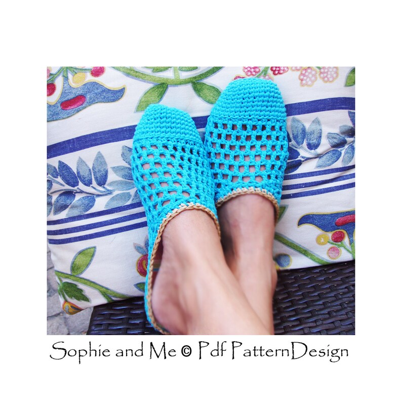 May include: A pair of turquoise blue crocheted slippers with a woven pattern. The slippers have a tan trim around the top edge.