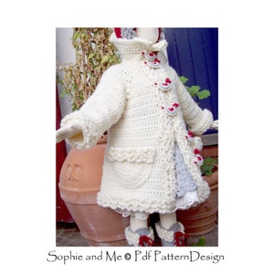 May include: A white crocheted coat with red and white buttons and a gray and white crocheted trim. The coat has a pocket on the front and a ruffled hem.