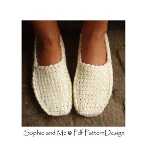 May include: A pair of white crocheted slippers. The slippers are made with a simple stitch pattern and have a rounded toe.
