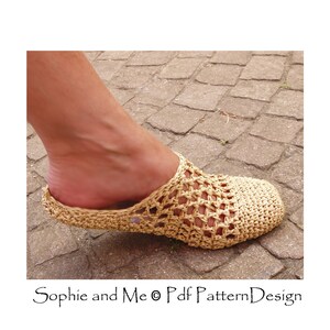 May include: A close-up of a crocheted beige slipper with a woven pattern. The slipper is on a stone surface.