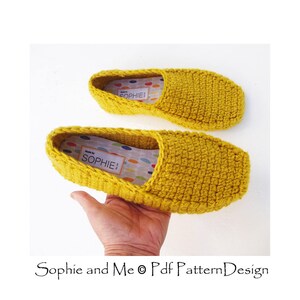 May include: A pair of mustard yellow crocheted slippers with a white label that says "Made by Sophie!"
