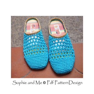 May include: A pair of blue crocheted slippers with a brown woven trim. The slippers have a grid pattern and are made with a soft yarn.