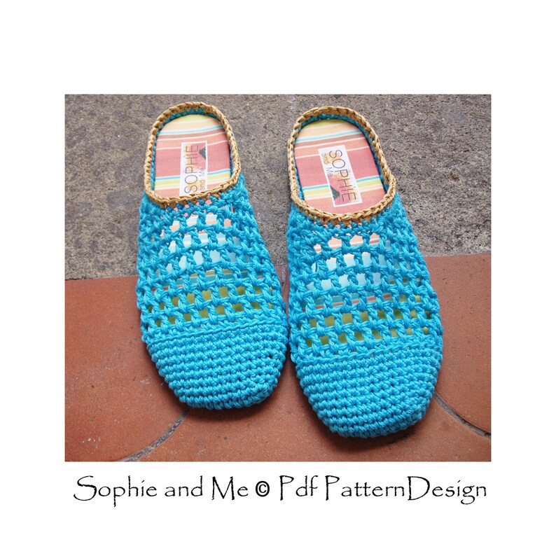 May include: A pair of blue crocheted slippers with a brown woven trim. The slippers have a grid pattern and are made with a soft yarn.