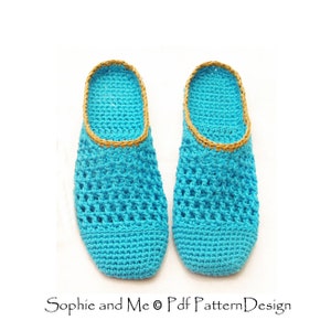 May include: A pair of crocheted slippers in a bright turquoise blue color with a gold trim around the top edge. The slippers are made with a simple open stitch pattern.