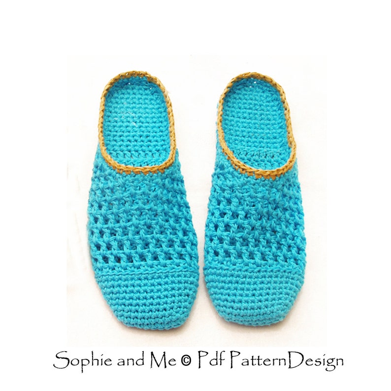 May include: A pair of crocheted slippers in a bright turquoise blue color with a gold trim around the top edge. The slippers are made with a simple open stitch pattern.