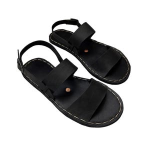 May include: A pair of black leather sandals. The sandals have a simple design with two wide straps and an ankle strap. The soles are stitched with light-coloured thread. The sandals are presented on a white background.