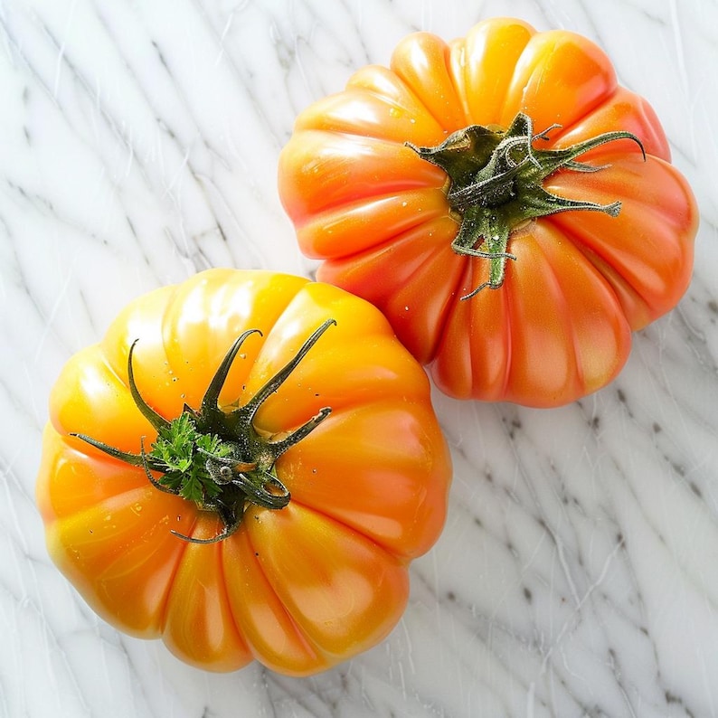 May include: Two heirloom tomatoes with ribbed surfaces and vibrant orange hues. The tomatoes have green stems and are displayed on a white marble surface. The tomatoes are a bright and fresh food item.