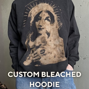 May include: A set of three ceramic mugs with a speckled, matte finish in cream, light grey, and dark grey. Each mug has a simple, minimalist design and a rounded handle.