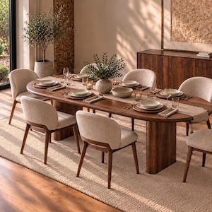 May include: An oval wooden dining table with a dark brown finish and two pedestal bases, surrounded by six chairs featuring light beige upholstered seats and backrests with dark wooden frames, set on a rectangular textured beige area rug.