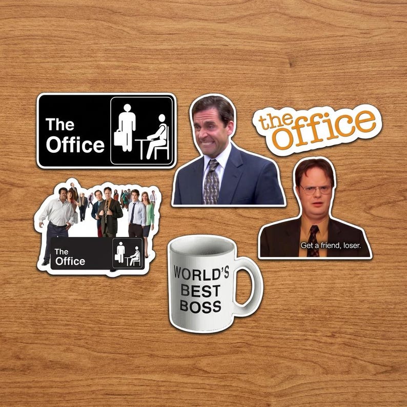 May include: A collection of stickers and a mug featuring imagery from the TV show "The Office." Stickers include the show's logo, characters, and the phrase "World's Best Boss" on a white mug. The stickers are various shapes and sizes.