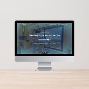 May include: A silver iMac computer showing a WordPress Dentist Website Template. The website features a dental office interior with dental equipment. The screen displays the text "WordPress Dentist Website Template" and navigation options.