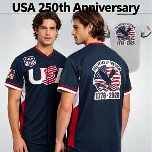 May include: A navy blue baseball jersey featuring the text USA 250th Anniversary. The front displays USA in white with red stripes, a USA 250 patch, and an American flag on the sleeve. The back shows a bald eagle, American flag, and 250 Years of Freedom 1776-2026.