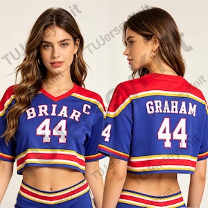 May include: A blue cropped jersey with red and yellow stripes on the sleeves and hem. The front features the text BRIAR and the number 44 in white. The back displays the name GRAHAM and the number 44 in white lettering on a blue background.