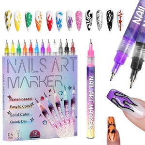 May include: A set of 12 nail art markers with a 0.5 mm tip, displayed with examples of nail art designs. The box reads "NAILS ART MARKER" and highlights features like water-based, easy to color, solid color, and quick dry.