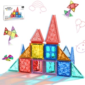 May include: Colorful magnetic building blocks arranged in a castle-like structure. The blocks are various shapes and transparent colors, including red, yellow, blue, and green. A box of the blocks is visible in the background, with the text "MAGNETIC BLOCKS" and "60 PCS".