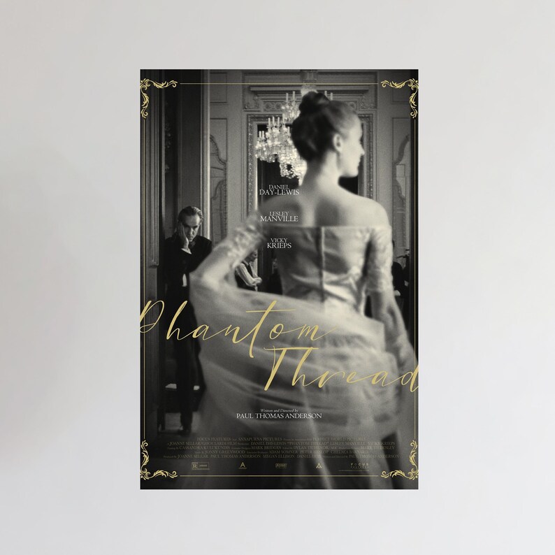 May include: A monochrome film poster for "Phantom Thread" showing a woman in an evening gown, viewed from behind. The title is in gold script, with the cast and director's names above and below. The poster has a decorative gold border.