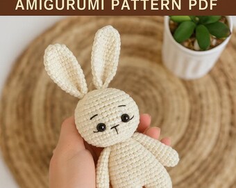 May include: A cream-colored crocheted bunny amigurumi with black eyes and a T-shaped mouth. The text "Cute Crochet Bunny" and "AMIGURUMI PATTERN PDF" are at the top. The bottom text says "Beginner-Friendly", "Step-by-Step Tutorial", and "Instant PDF Download".