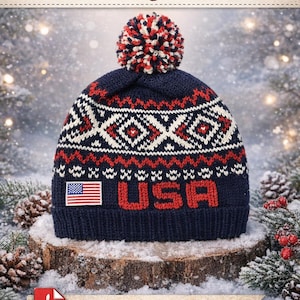 May include: A navy blue knit beanie with a red, white, and blue geometric pattern and a pom-pom. The word "USA" is displayed in red block letters, with a small American flag patch. The text "USA Knit Beanie - PDF Knitting Pattern" is at the top.