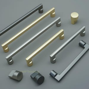 Puede incluir: Una variedad de herrajes modernos para gabinetes en varios acabados metálicos, incluyendo negro, dorado y plateado. La colección presenta tiradores de barra y estilos de pomo, ideales para renovaciones de cocina o muebles. Los herrajes se muestran sobre una superficie gris.