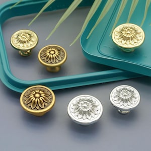 May include: A set of three ceramic mugs with a speckled, matte finish in cream, light grey, and dark grey. Each mug has a simple, minimalist design, suitable for coffee or tea.