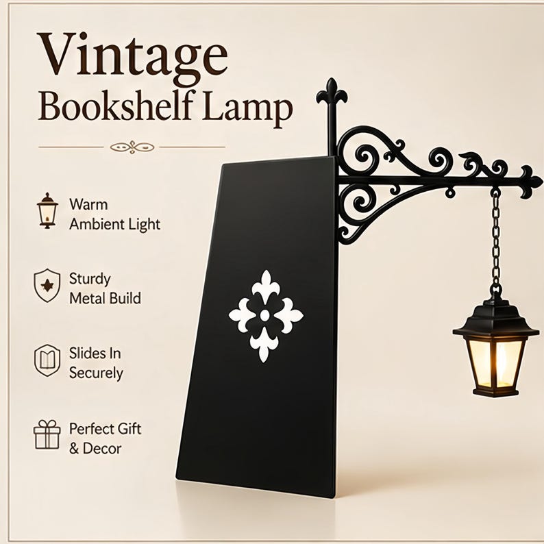 May include: A black metal bookshelf lamp featuring a decorative scrollwork bracket and a hanging lantern with warm light. The lamp includes a flat vertical panel with a white fleur-de-lis emblem. Text on the image reads Vintage Bookshelf Lamp.