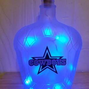 Homemade Dallas cowboys recycled crown royal bottle battery operated light.