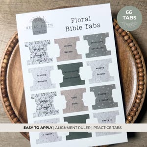 May include: Floral Bible tabs with botanical designs. The tabs are labeled with book names and include the text "HELLO FAITH" and "66 TABS". The bottom of the sheet reads "EASY TO APPLY | ALIGNMENT RULER | PRACTICE TABS".