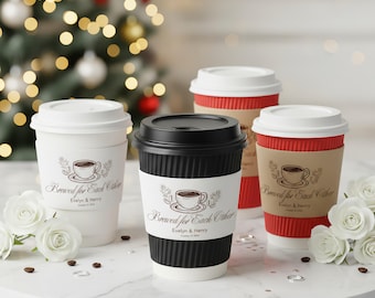 May include: Four disposable coffee cups with lids, in white, black, and red, are arranged on a marble surface. Each cup has a paper sleeve with the text "Brewed for Each Other" and a coffee cup illustration. White roses and coffee beans are scattered around.