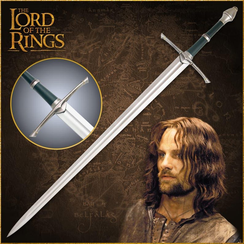 May include: A long, silver sword with a green and silver handle, as seen in the Lord of the Rings. The sword has a cross-shaped hilt and a pointed tip. The image also features the text "THE LORD OF THE RINGS".