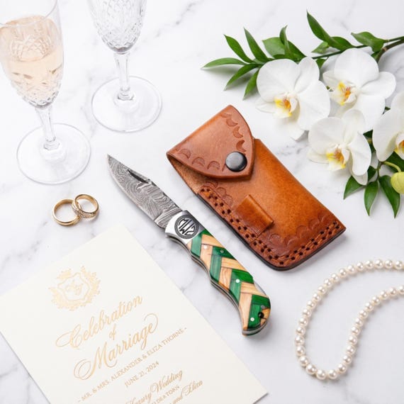 Real Damascus steel folding knife with custom engraving — the swirling layered-steel pattern alone makes this a display-worthy EDC and standout groomsmen gift.