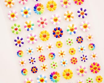 May include: Sheet of colorful flower stickers with smiling faces. The stickers feature a variety of colors, including yellow, pink, blue, and purple. Each flower has a smiling face with a red mouth.