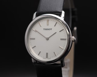 Relógio masculino Tissot vintage dos anos 1990, mostrador branco, quartzo, 32 mm, fabricado no Japão. Em estado impecável.