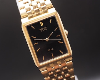 Reloj Seiko SX V701-5K40 vintage de 1980 con esfera negra, caja Gold Tank Qz de 24 mm para hombre, fabricado en Japón.