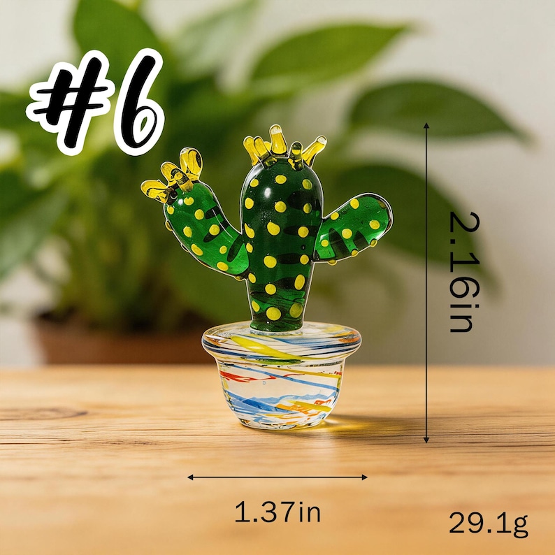 May include: A glass cactus figurine with green body and yellow polka dots, in a colorful pot. The cactus is 2.16 inches tall and 1.37 inches wide. The figurine weighs 29.1 grams. The number 6 is in the upper left corner.