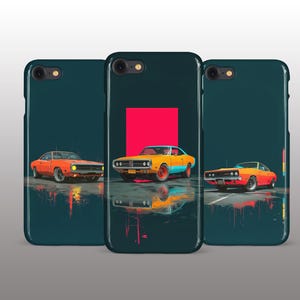 May include: Three phone cases with a teal background and a classic car design. The cars are orange and yellow, with a red square in the background of the center case. The cars are reflected in the wet surface.