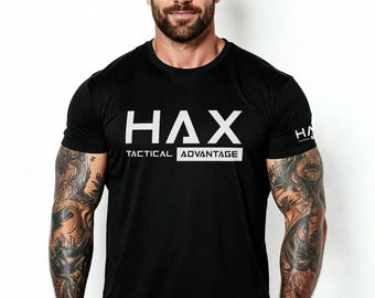 May include: Black crew neck t-shirt with the white text "HAX TACTICAL ADVANTAGE" across the chest. The shirt has short sleeves and a small "HA" logo on the right sleeve. The model is wearing the shirt.