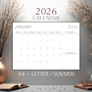 May include: A white 2026 calendar showing January. The calendar has sections for tasks, reminders, and goals. The text "2026 CALENDAR" is at the top. The calendar is labeled "A4 • LETTER • SUN/MON".